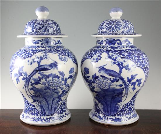 A pair of large Chinese blue and white baluster jars and covers, Kangxi marks, late 19th century, 41.5cm